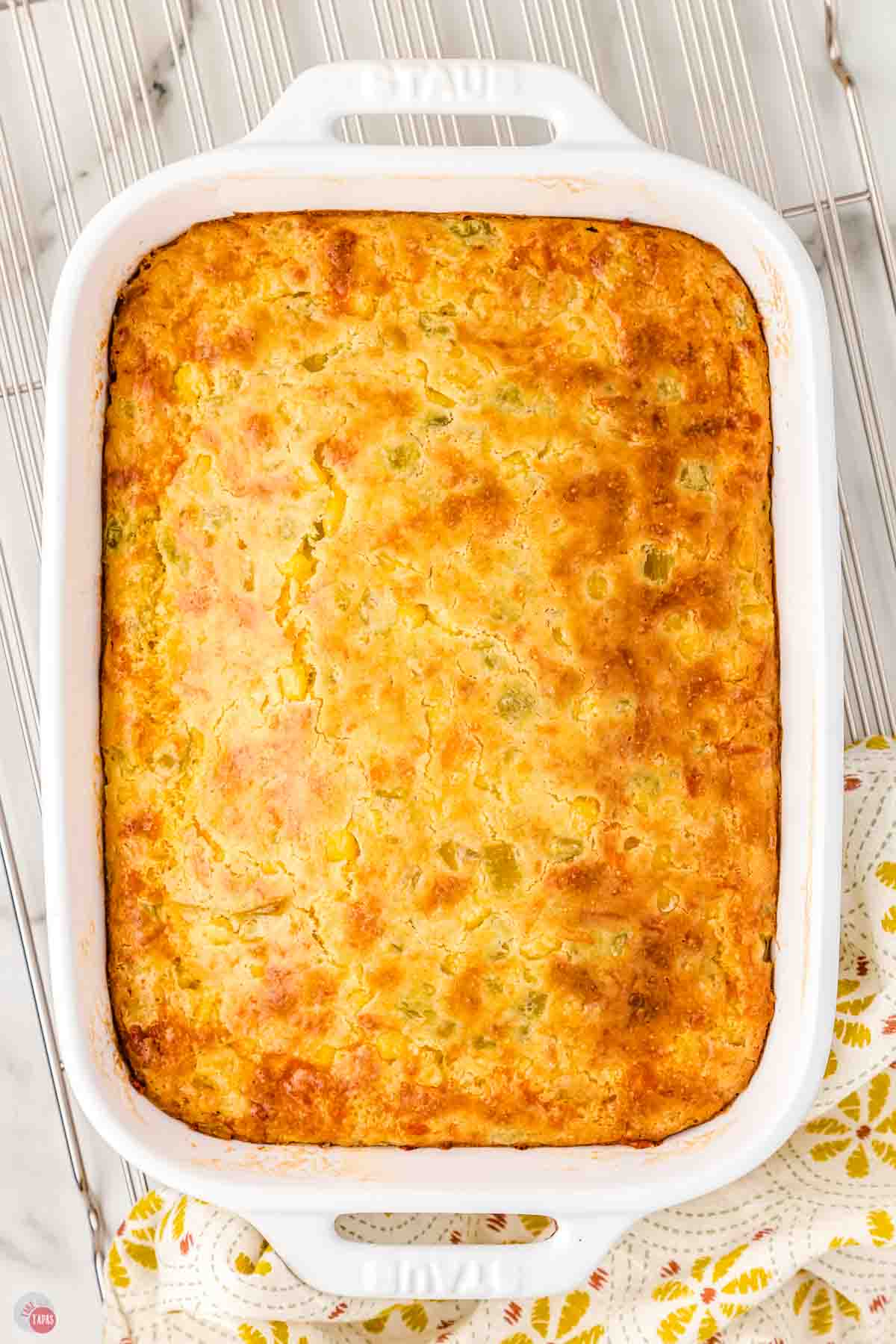 baked green chili corn casserole in a white dish