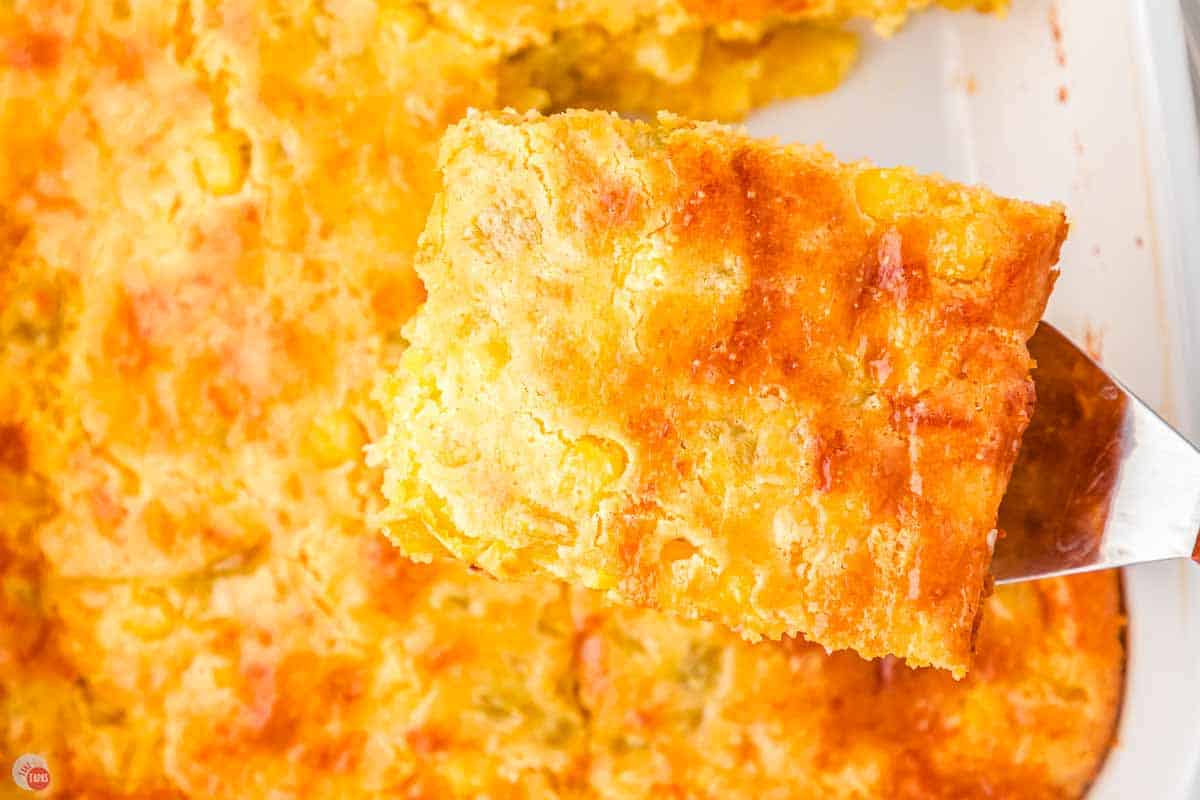 slice of cornbread casserole being removed from a dish