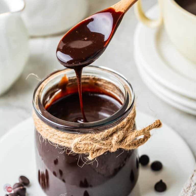 spoon drizzling hot fudge sauce back into a small jar wrapped with twine