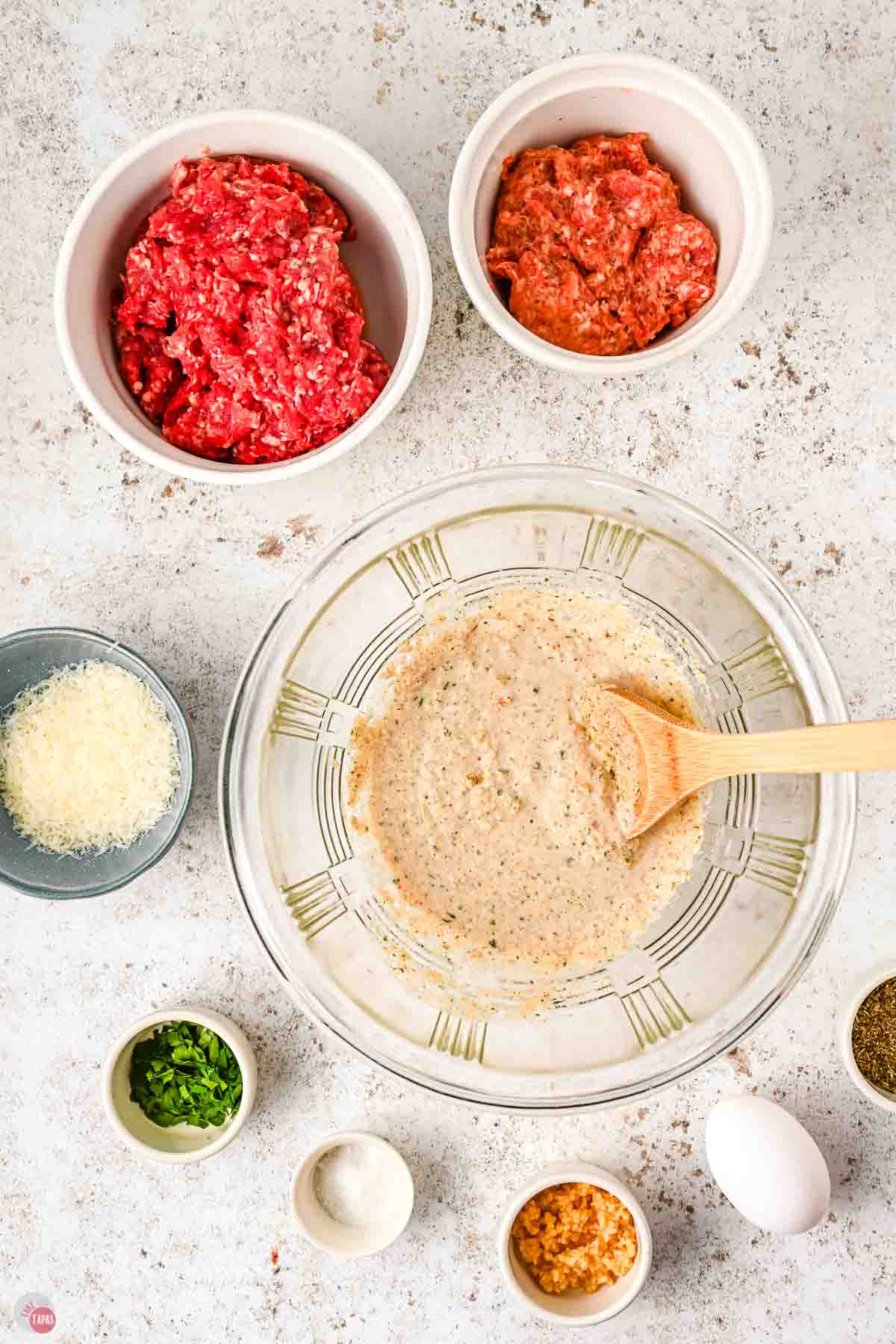 clear bowl with milk and breadcrumbs bring mixed together