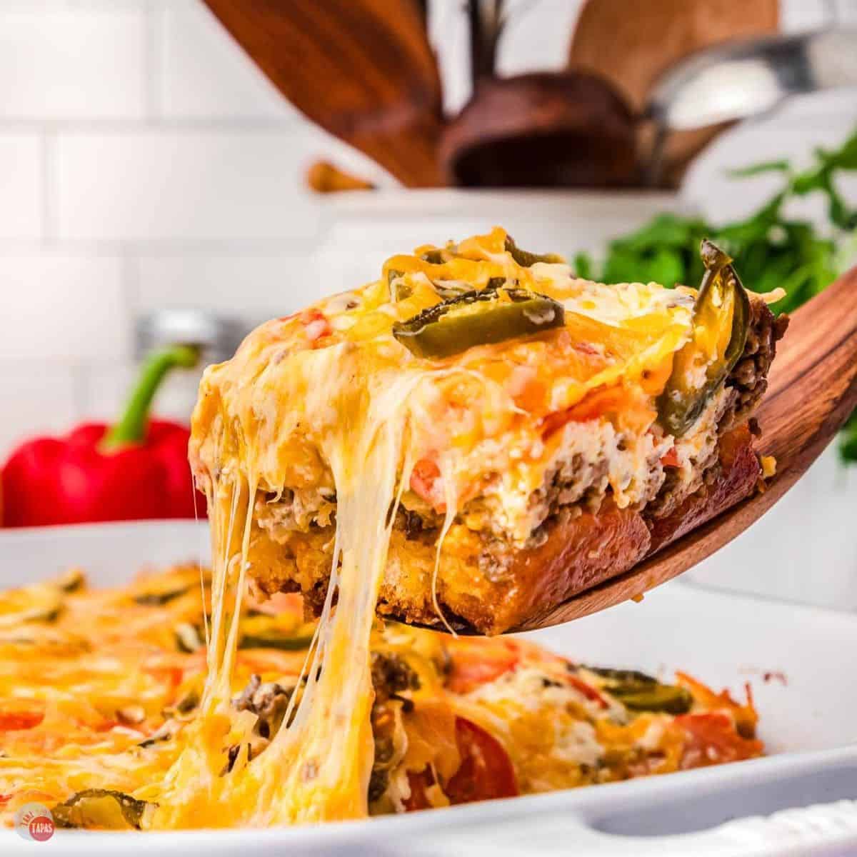 slice of john wayne casserole on a wood spoon