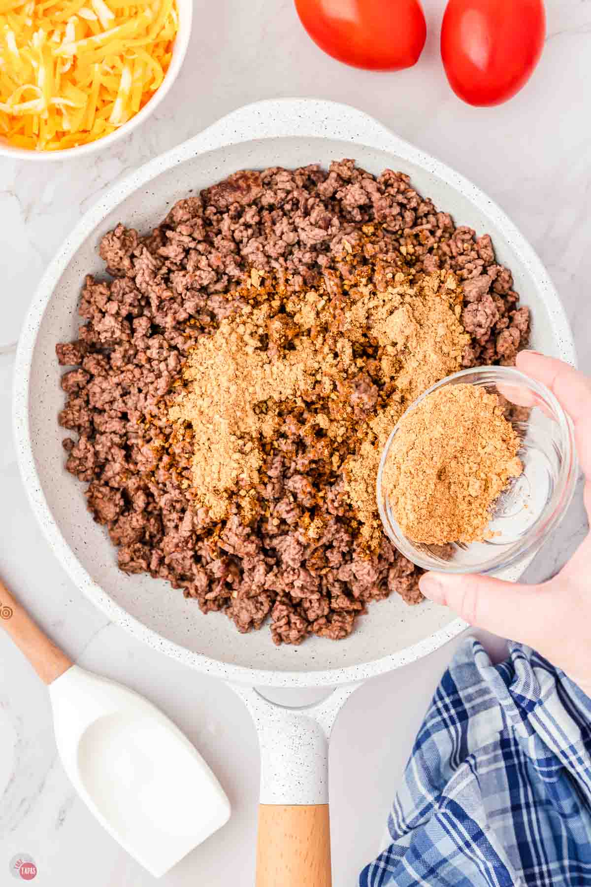 ground beef cooking in a skillet with taco seasoning