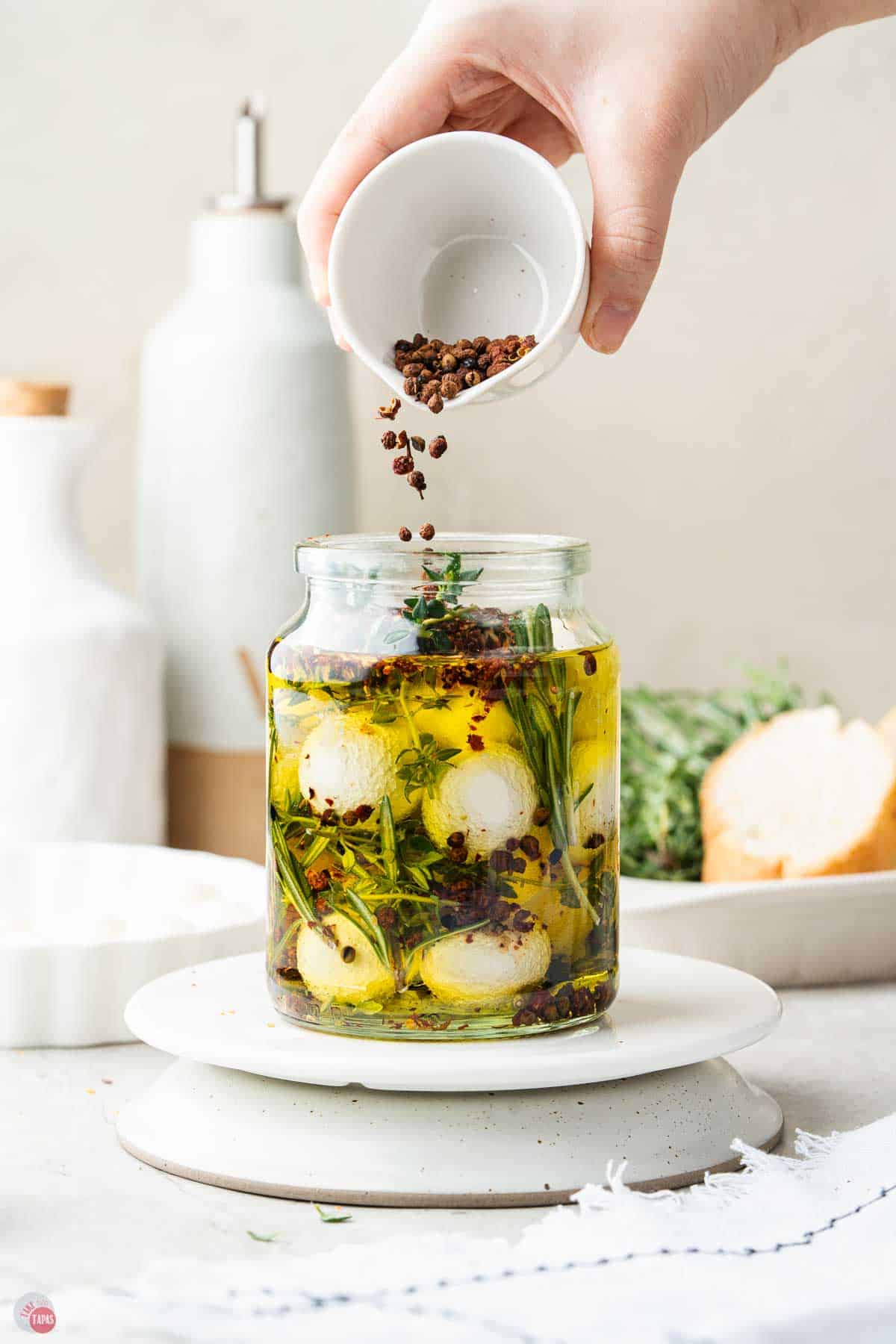 jar of mozzarella balls with olive oil and spices