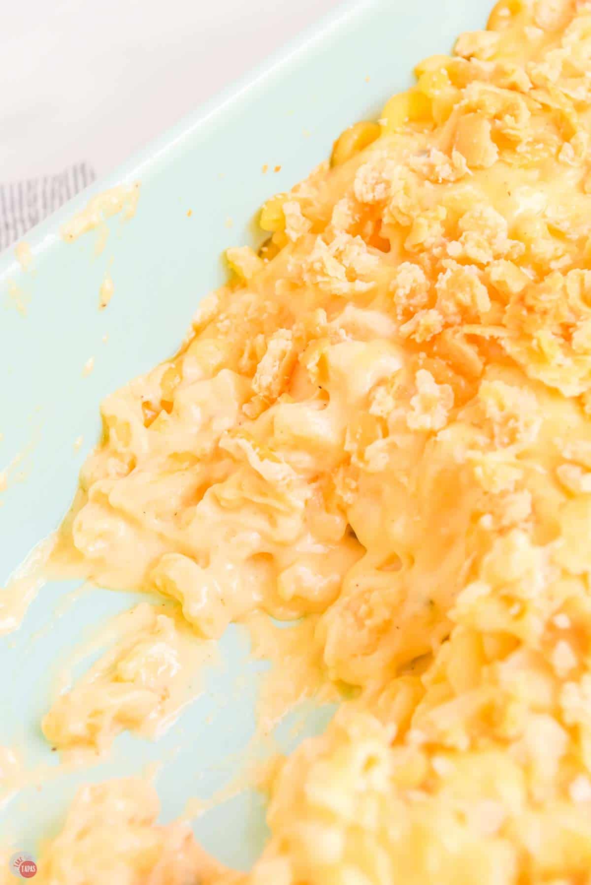 casserole dish full of old fashioned baked mac and cheese with a scoop missing