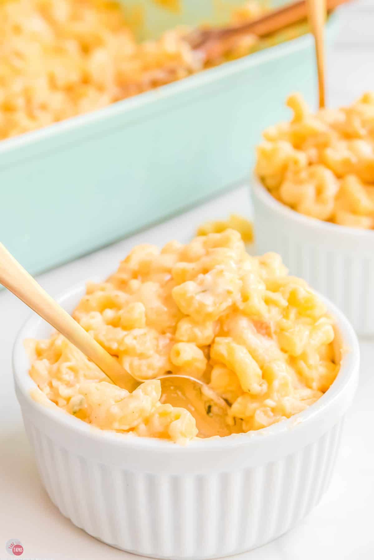 small bowl of mac and cheese with a gold spoon in it