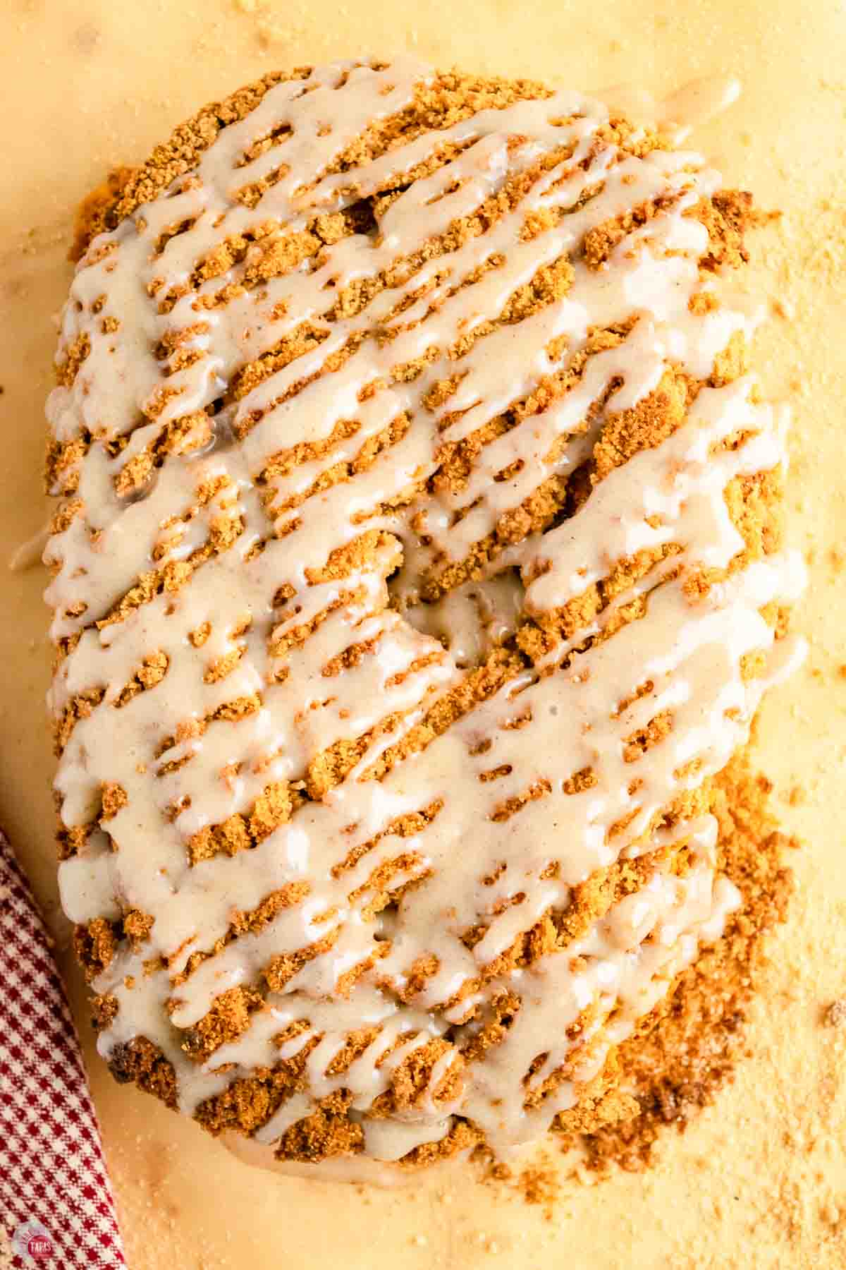 close up of pumpkin streusel bread with glaze on top