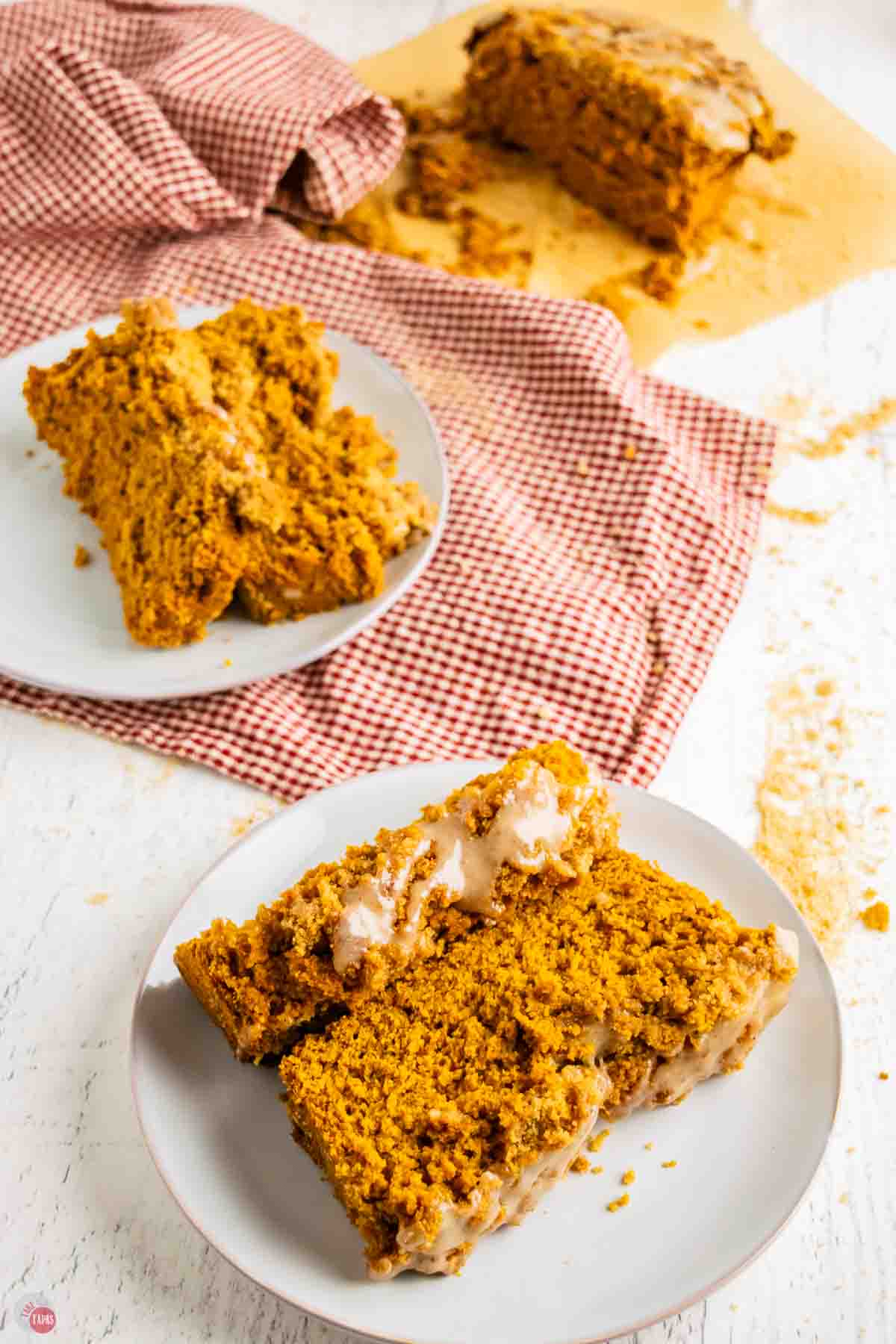 two slices of pumpkin bread on white plates