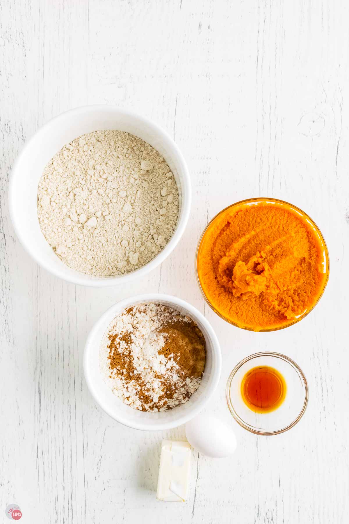 bowls of cake mix, pumpkin puree, and extracts