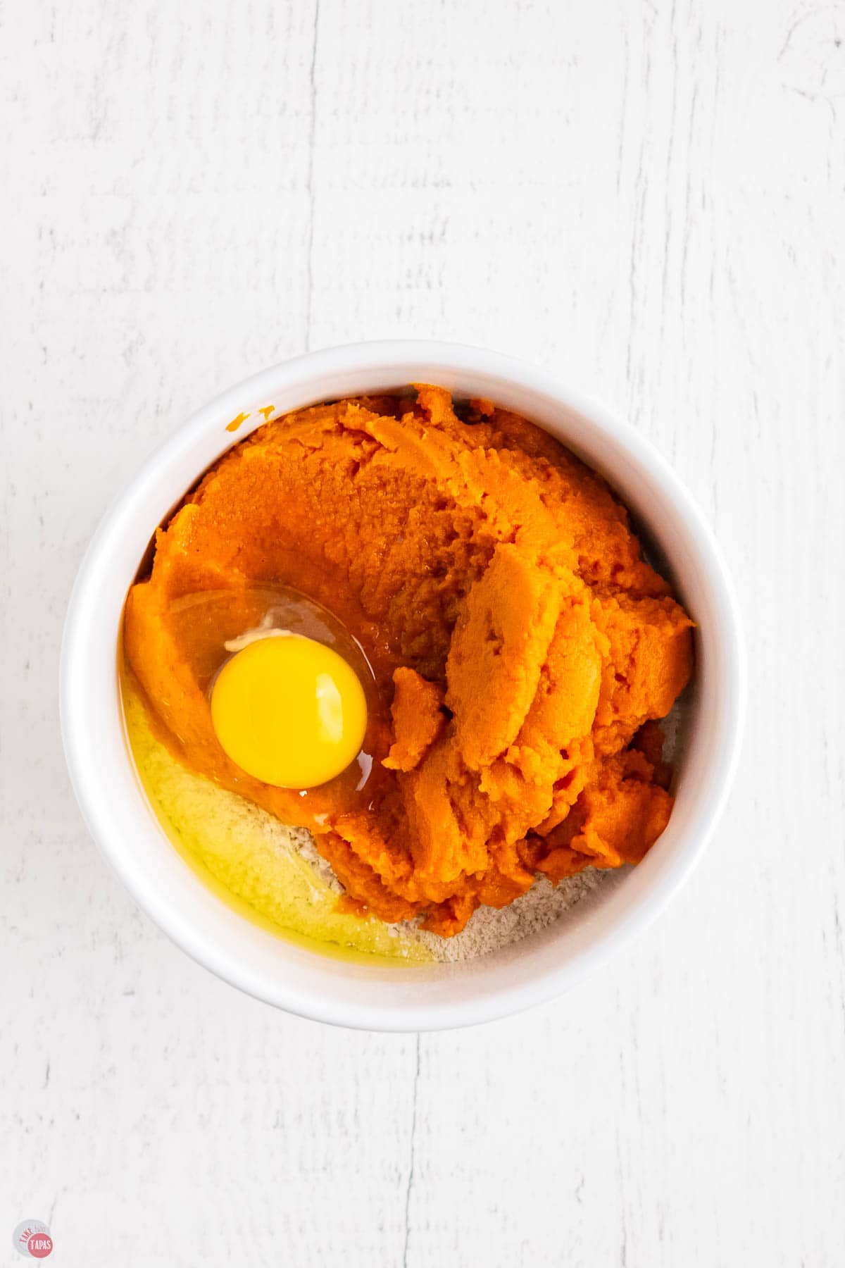 large mixing bowl of cake mix, puree, melted butter, and egg