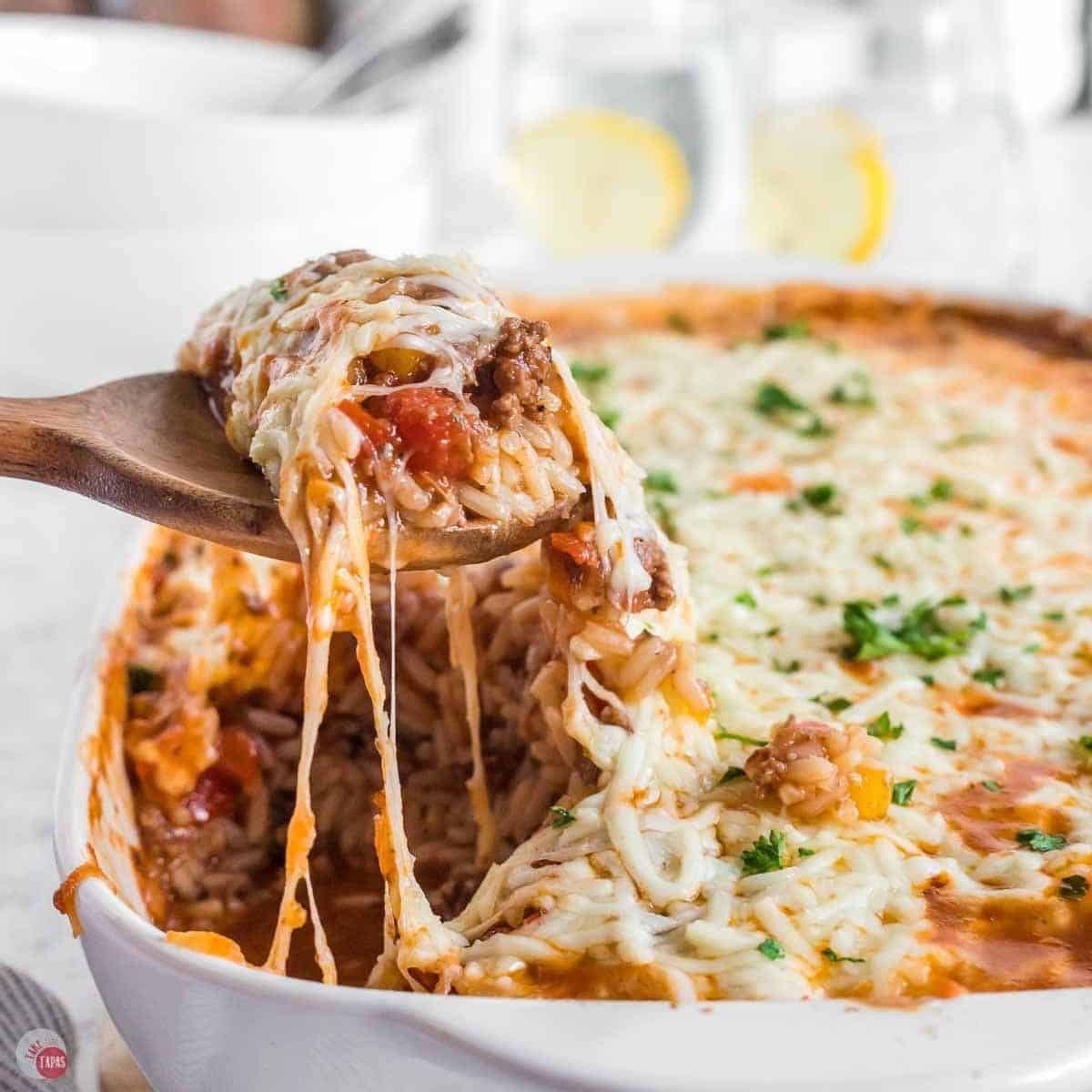 scoop of stuffed pepper casserole being removed from the baking dish