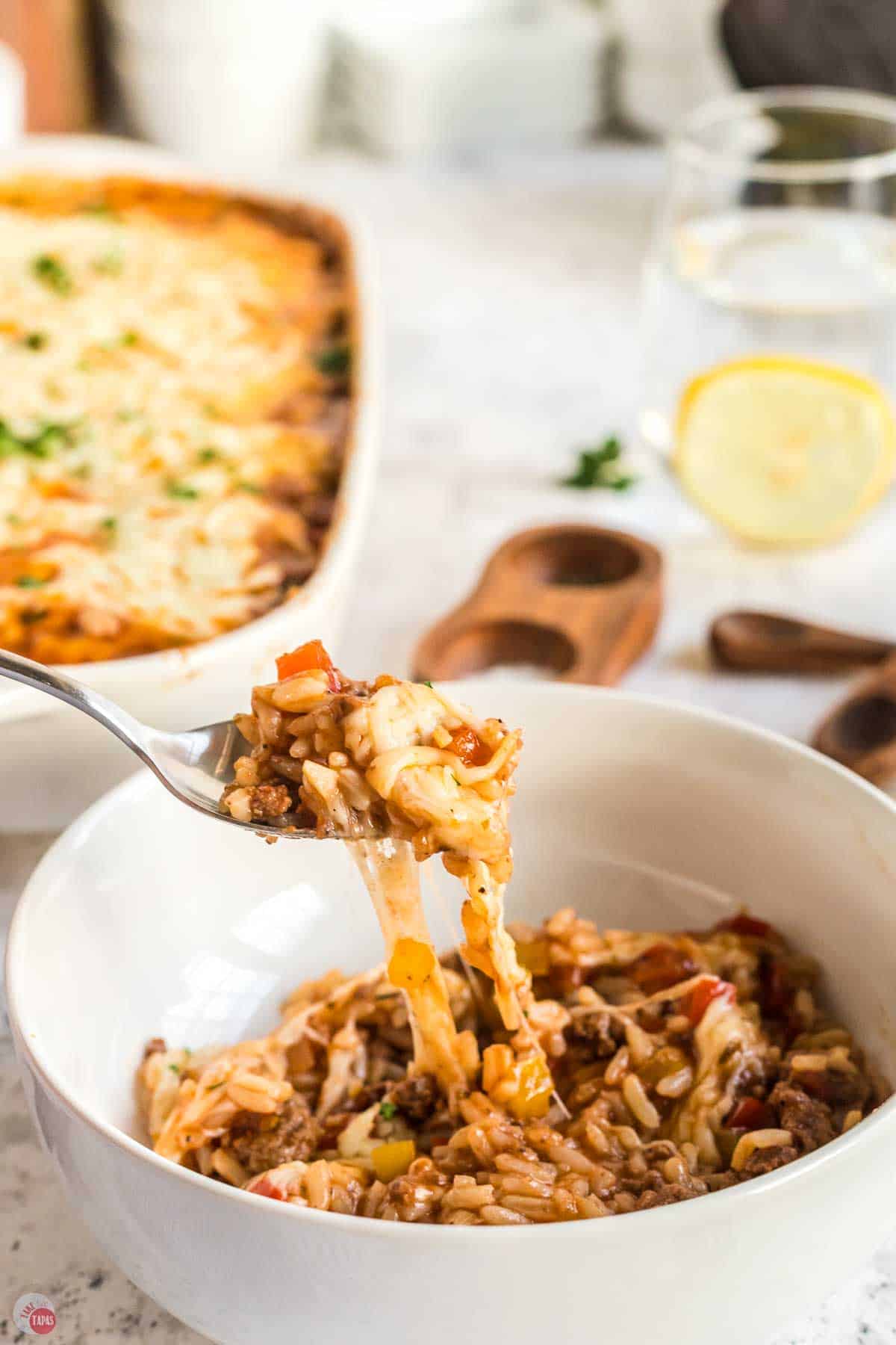 close up of fork with bite of casserole on it