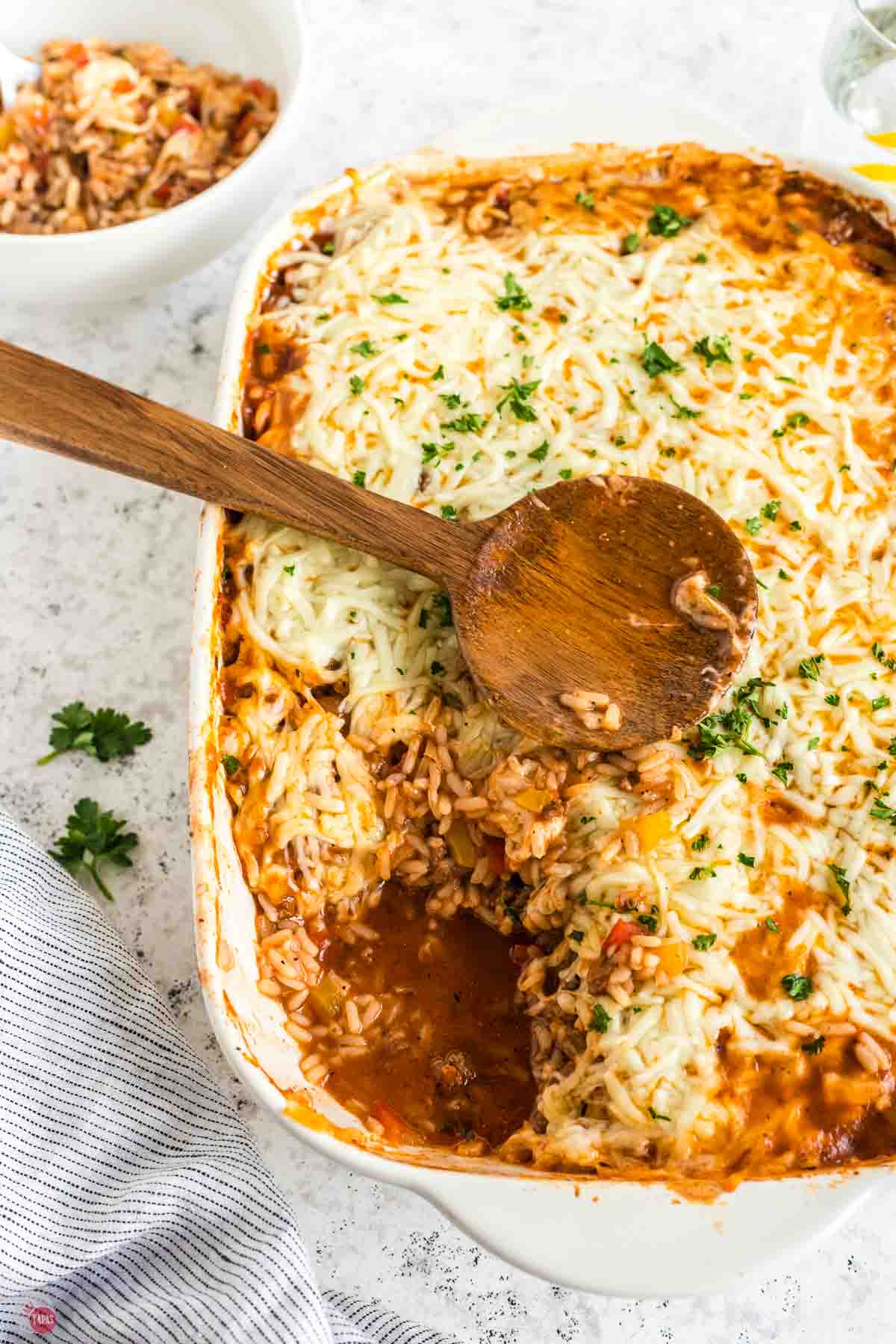 stuffed bell pepper casserole in a white dish with a scoop missing