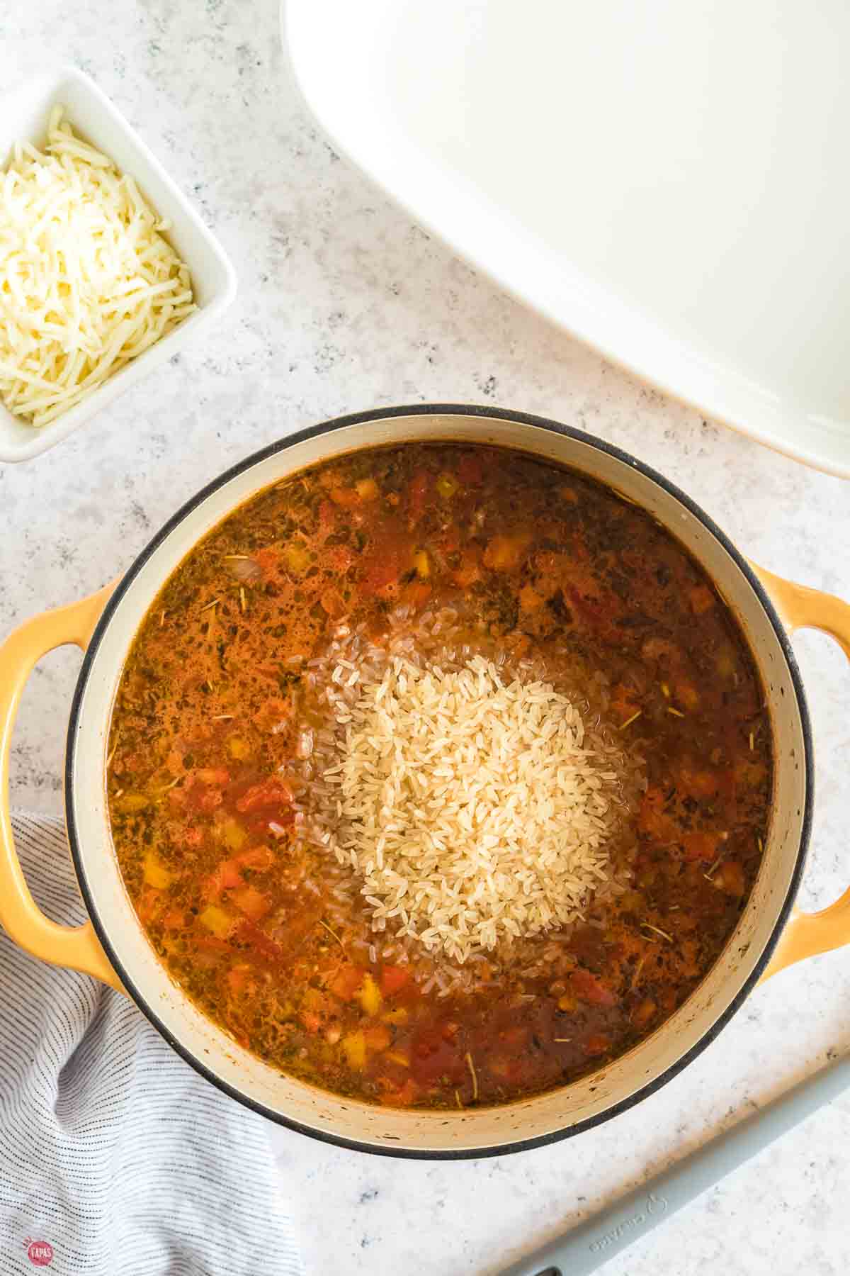 pot of tomato ground beef mixture with a pile of rice on top