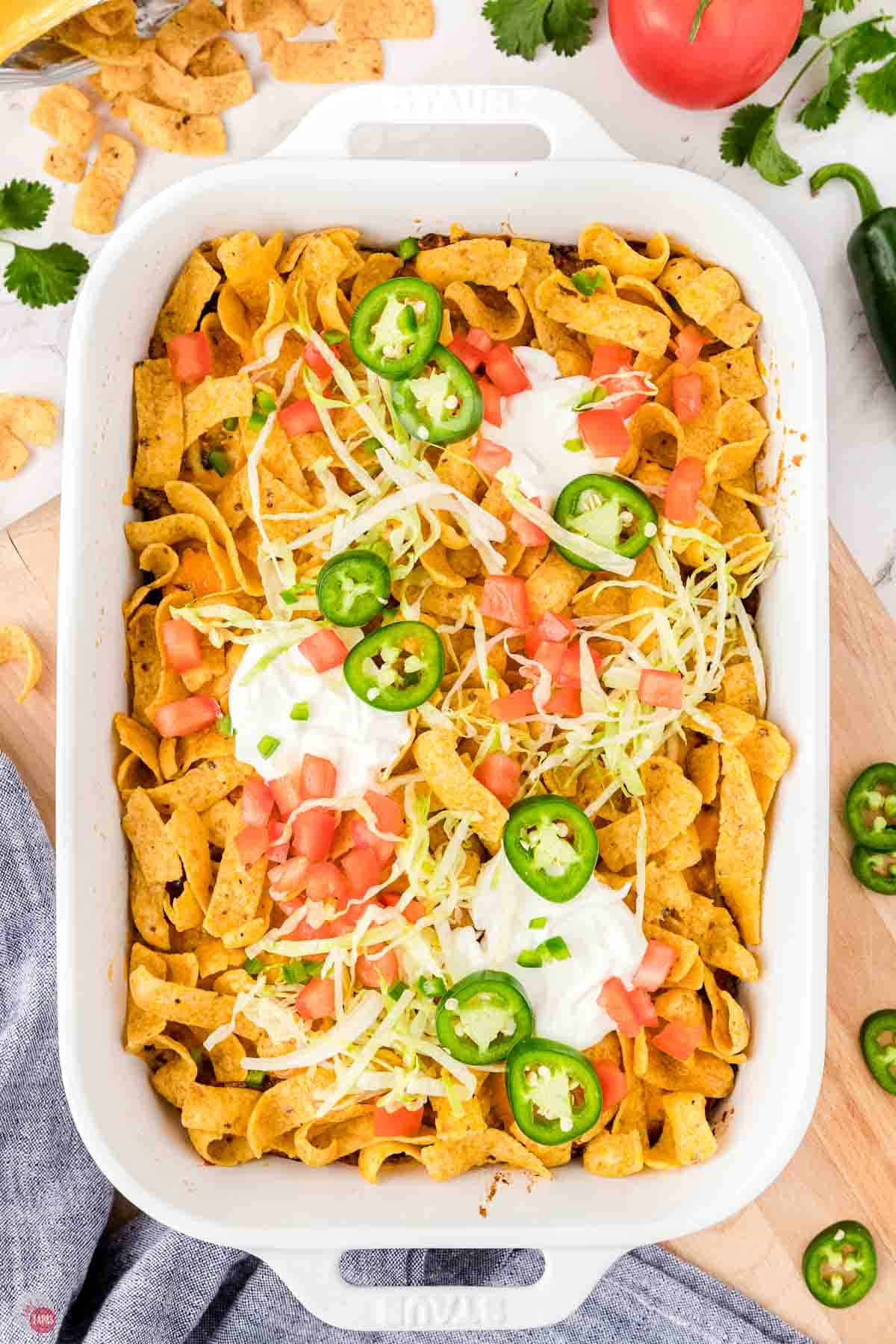 walking taco casserole in a white baking dish