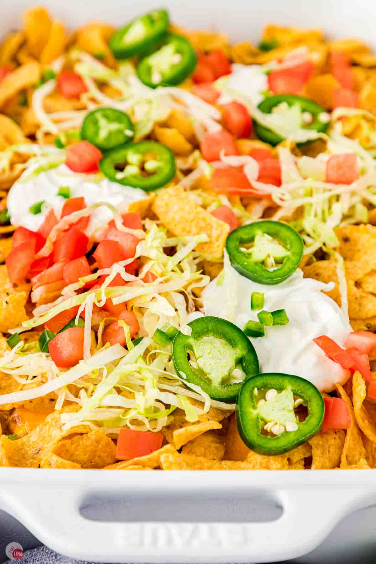 close up of toppings on a casserole with Frito corn chips