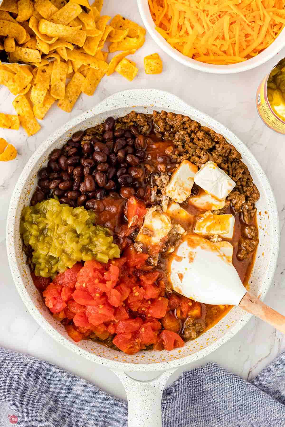 skillet with mixture of tomatoes, chilies, cream cheese, beans, and ground beef