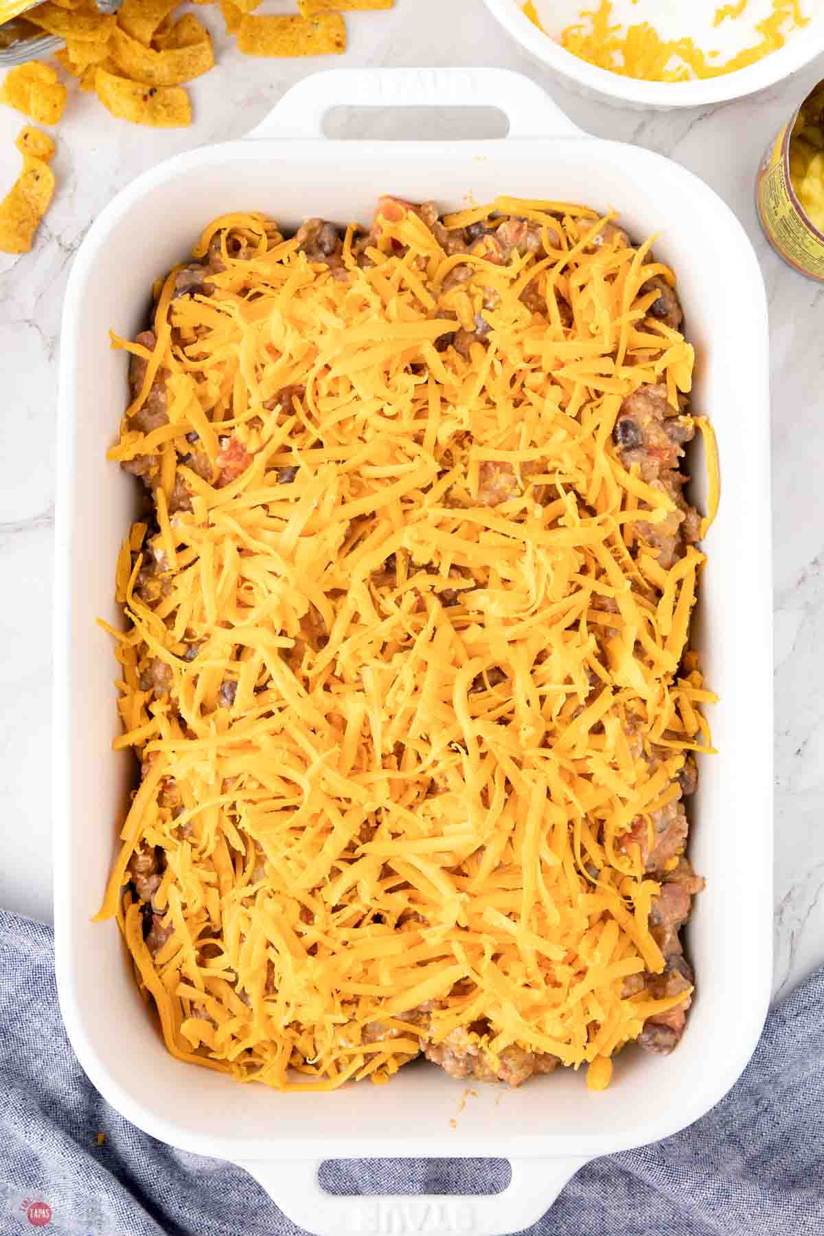 casserole topped with shredded cheese in a white dish