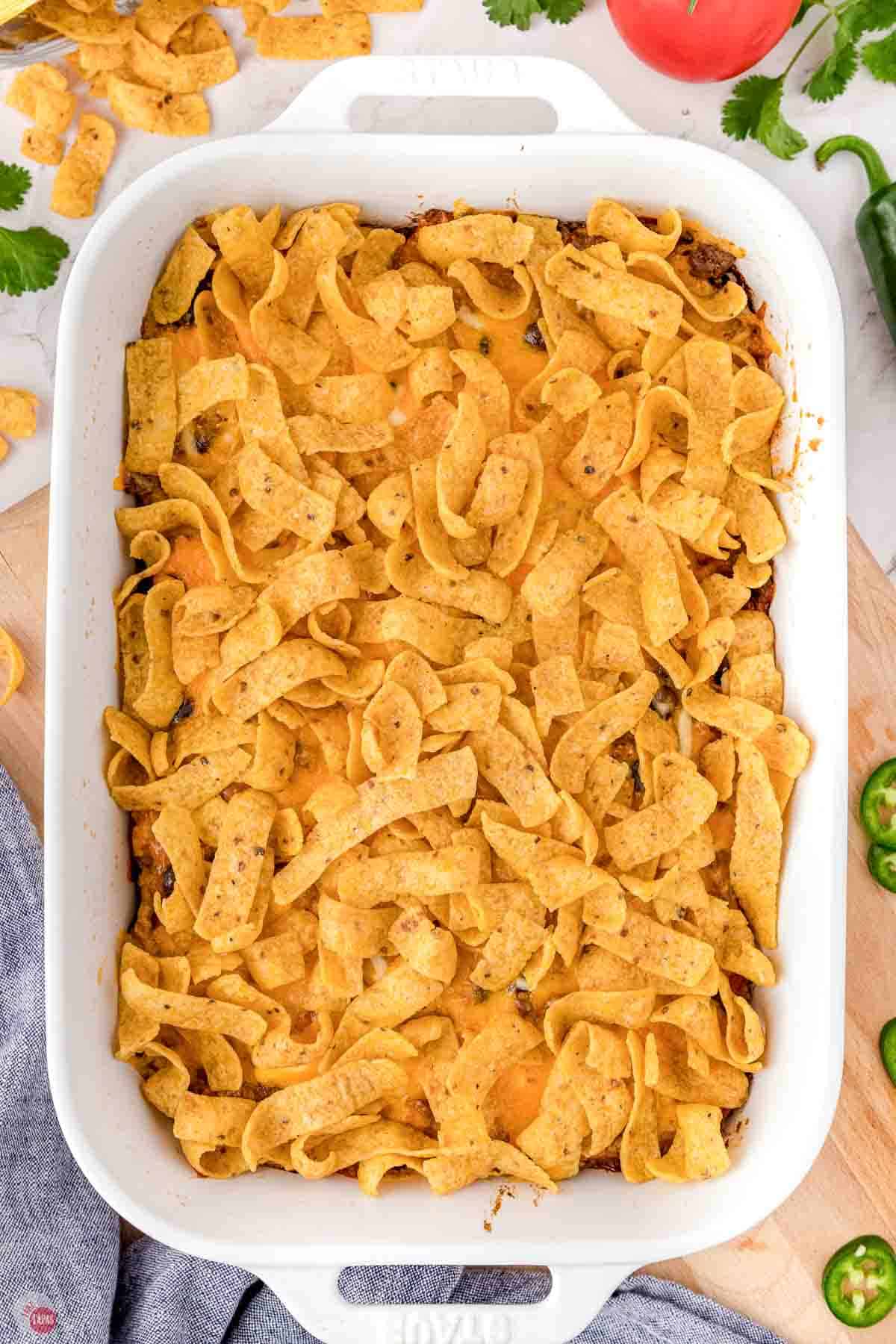 baked walking taco casserole in a white dish